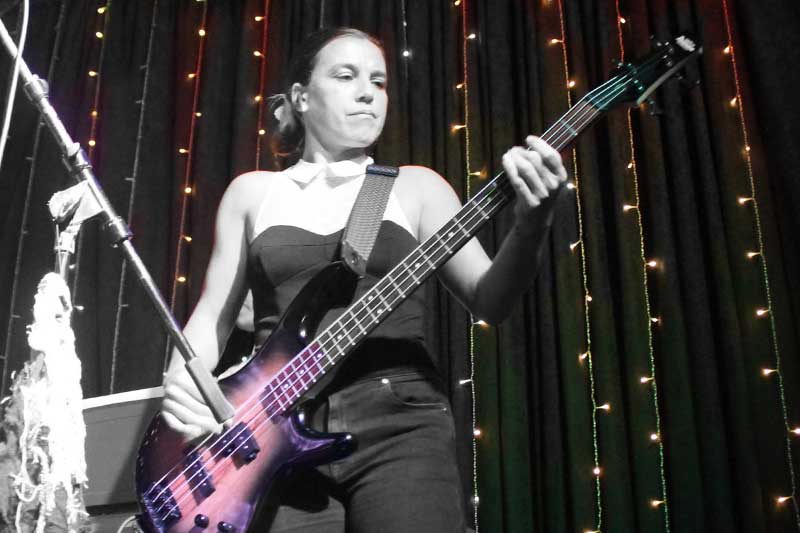 Adult playing bass on stage