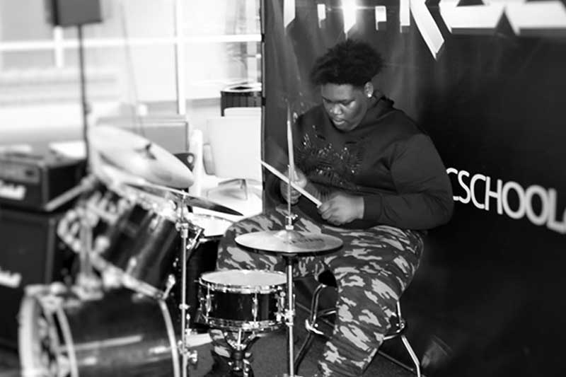Teen playing drums after 3 months of lessons